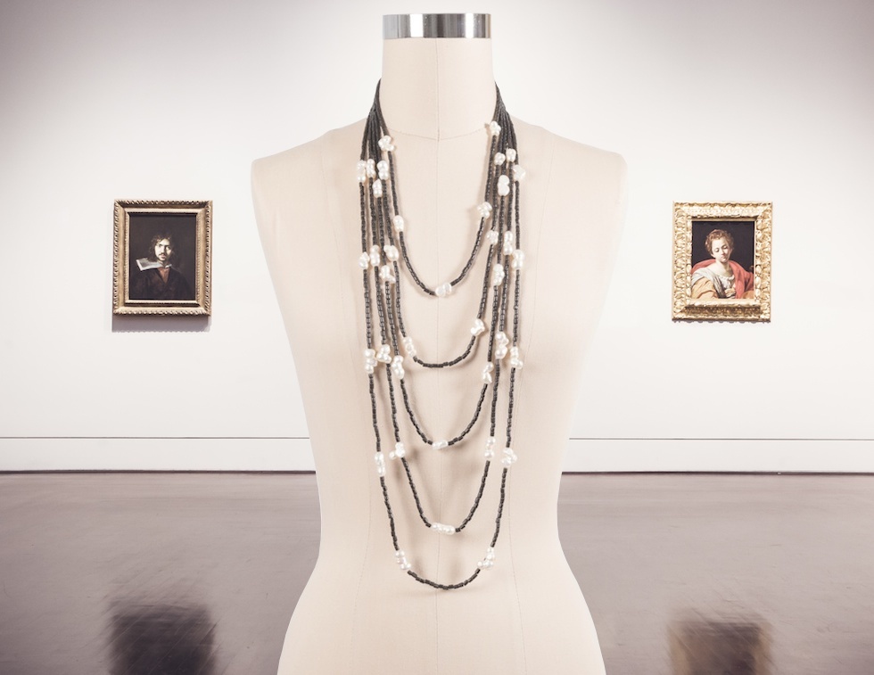layered pearl necklace in a gallery